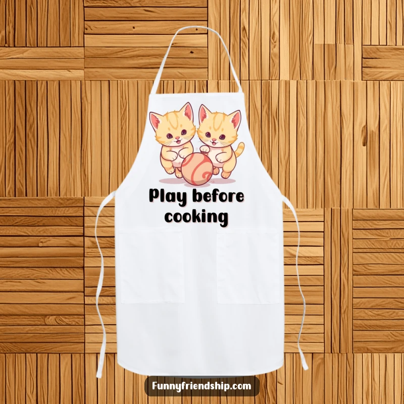 Funny kitchen apron showcasing two kittens playfully chasing a bright bouncing ball, perfect for adding humor to cooking and baking activities.