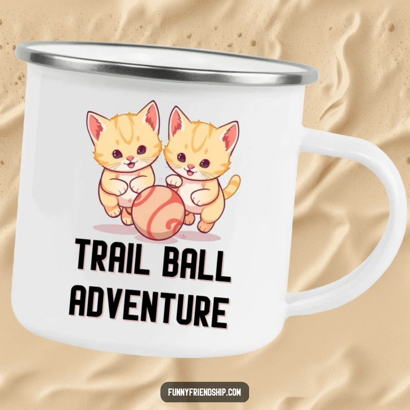 Funny enamel camping mug displaying two energetic kittens playfully chasing a bouncing ball, ideal for adding cheer to outdoor adventures.
