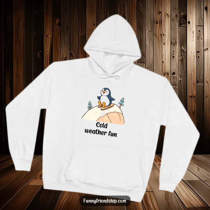 Funny hoodie with a cheerful penguin character sliding down a hill alongside a friend, offering warmth and joyful friendship.