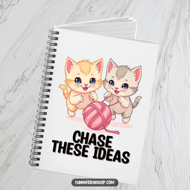 Funny playful kittens chasing a bouncing ball of yarn together on a spiral notebook cover, a cute stationery item
